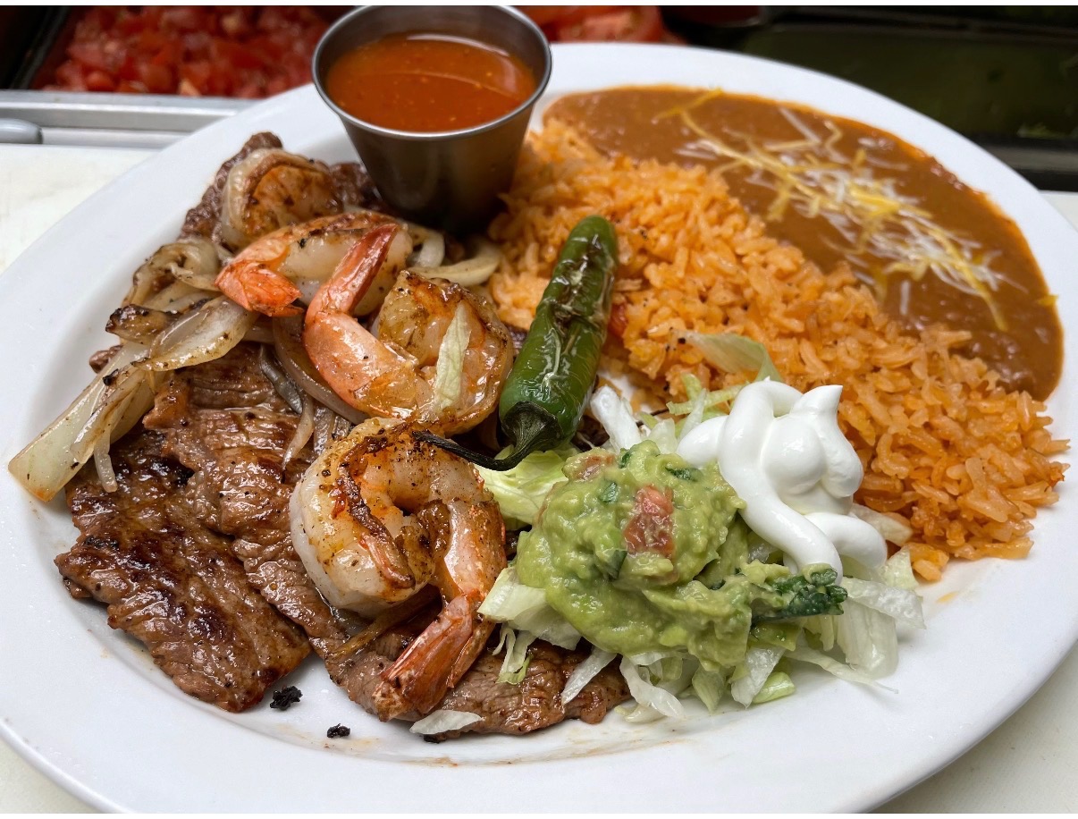 Steak and shrimp plate with rice, beans, and guacamole