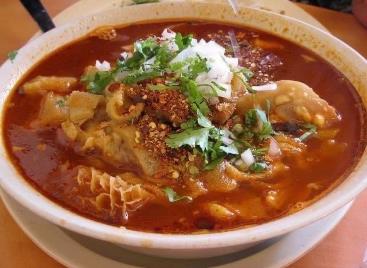 Bowl of menudo with hominy, cilantro, onion, and chile at Los Primos
