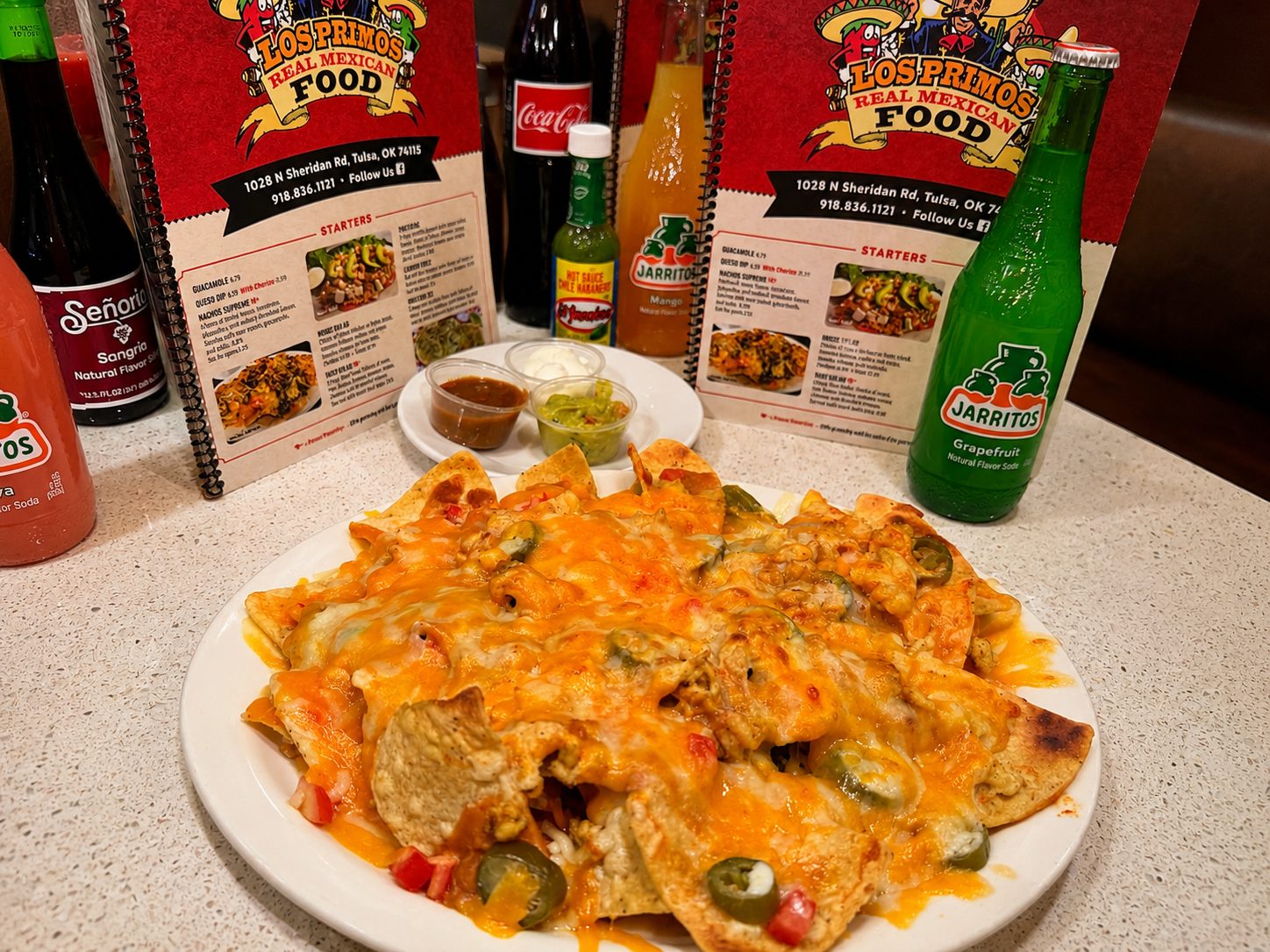 Nachos Supreme loaded with cheese and jalapeños at Los Primos
