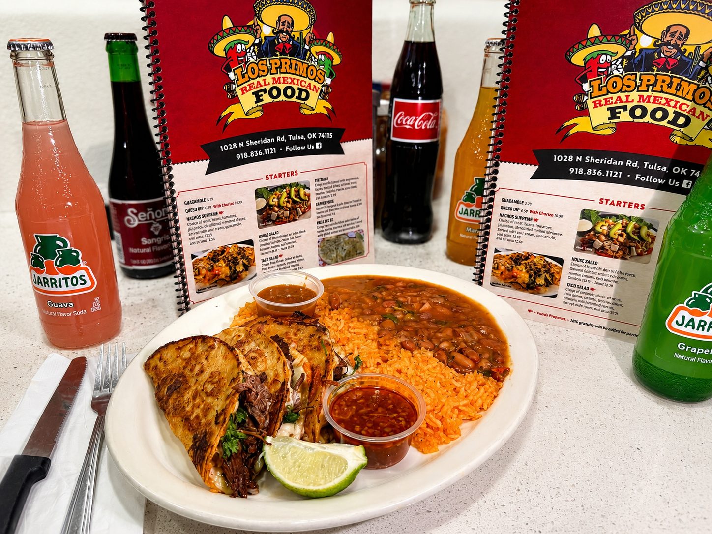 Quesabirria taco combo with consomé, rice, and beans at Los Primos