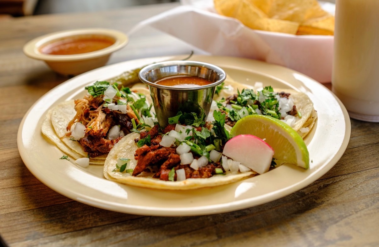 Street tacos with cilantro, onion, radish, and lime at Los Primos